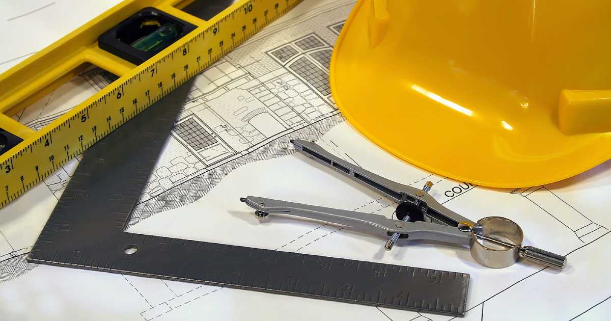 hard hat and architect tools sitting on home construction plans