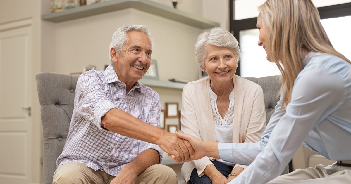 smiling people shaking hands